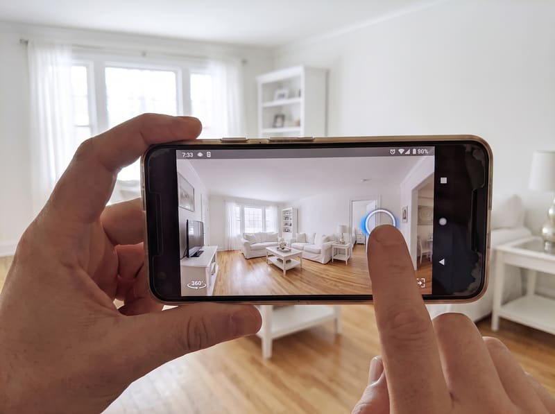A phone screen showing a living room photo with a tappable hotspot near a doorway